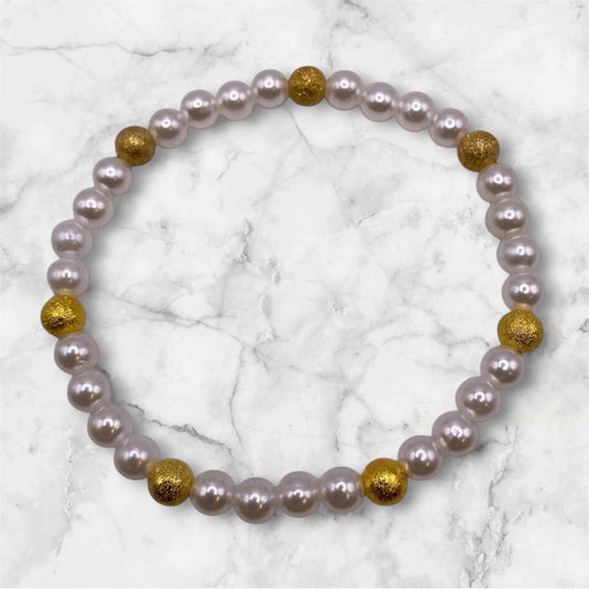 Pärlarmband med vita glaspärlor och guldfärgade stardustpärlor