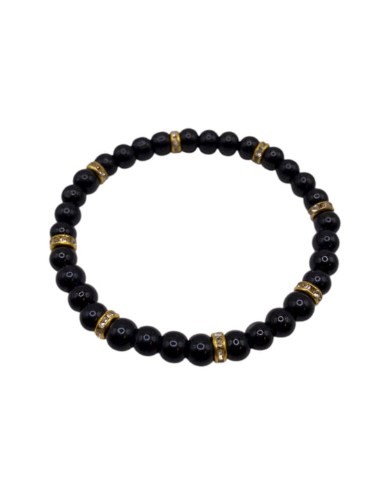 Svart pärlarmband med guld strasstenar